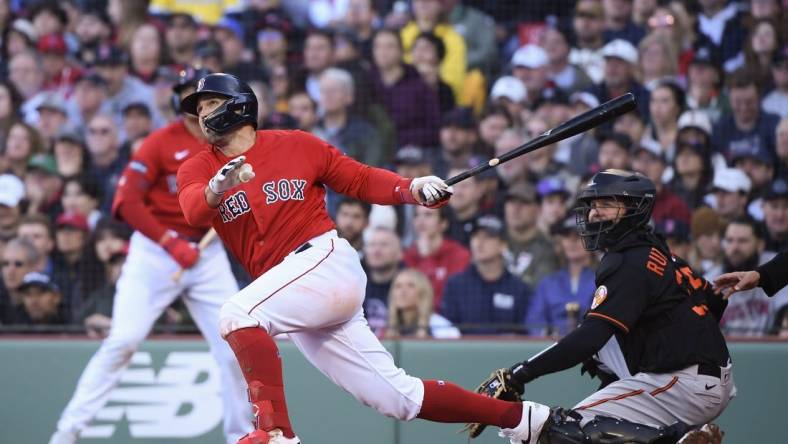 Apr 1, 2023; Boston, Massachusetts, USA;  Boston Red Sox center fielder Adam Duvall (18) hits a two-run home run during the third inning against the Baltimore Orioles at Fenway Park. Mandatory Credit: Bob DeChiara-USA TODAY Sports