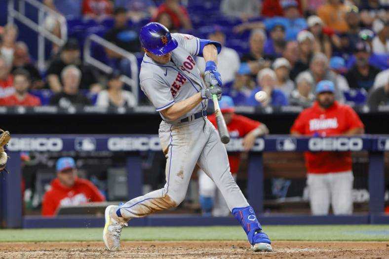 Apr 1, 2023; Miami, Florida, USA; New York Mets left fielder Mark Canha (19) hits an RBI single during the fifth inning against the Miami Marlins at loanDepot Park. Mandatory Credit: Sam Navarro-USA TODAY Sports
