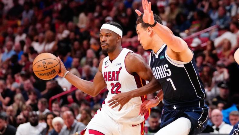 Apr 1, 2023; Miami, Florida, USA; Miami Heat forward Jimmy Butler (22) throws a pass against Dallas Mavericks center Dwight Powell (7) during the second quarter at Miami-Dade Arena. Mandatory Credit: Rich Storry-USA TODAY Sports