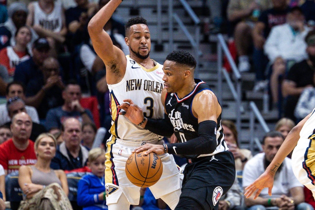 Apr 1, 2023; New Orleans, Louisiana, USA;  LA Clippers guard Russell Westbrook (0) dribbles against New Orleans Pelicans guard CJ McCollum (3) during the first half at Smoothie King Center. Mandatory Credit: Stephen Lew-USA TODAY Sports