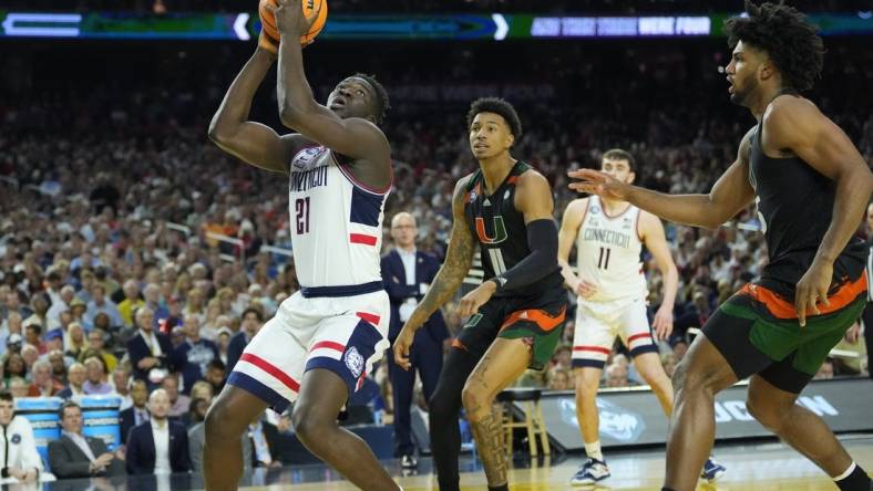 Apr 1, 2023; Houston, TX, USA; Connecticut Huskies forward Adama Sanogo (21) shoots against the Miami Hurricanes in the semifinals of the Final Four of the 2023 NCAA Tournament at NRG Stadium. Mandatory Credit: Robert Deutsch-USA TODAY Sports