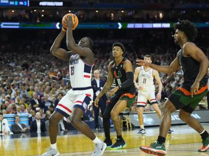 Apr 1, 2023; Houston, TX, USA; Connecticut Huskies forward Adama Sanogo (21) shoots against the Miami Hurricanes in the semifinals of the Final Four of the 2023 NCAA Tournament at NRG Stadium. Mandatory Credit: Robert Deutsch-USA TODAY Sports