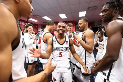 Apr 1, 2023; Houston, TX, USA; San Diego State Aztecs guard Lamont Butler (5) celebrates in the locker room with teammates in the semifinals of the Final Four in the 2023 NCAA Tournament against the Florida Atlantic Owls at NRG Stadium. Mandatory Credit: Jamie Schwaberow/Pool Photo-USA TODAY Sports