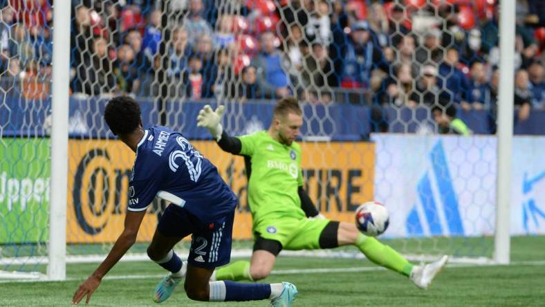 Apr 1, 2023; Vancouver, British Columbia, CAN; CF Montreal goalkeeper Jonathan Sirois (40) makes a save against Vancouver Whitecaps forward Ali Ahmed (22) during the first half at BC Place. Mandatory Credit: Anne-Marie Sorvin-USA TODAY Sports