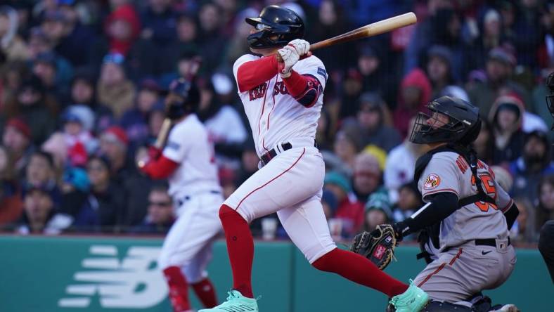 Apr 2, 2023; Boston, Massachusetts, USA; Boston Red Sox shortstop Enrique Hernandez (5) singles to right field to drive in a run against the Baltimore Orioles in the seventh inning at Fenway Park. Mandatory Credit: David Butler II-USA TODAY Sports