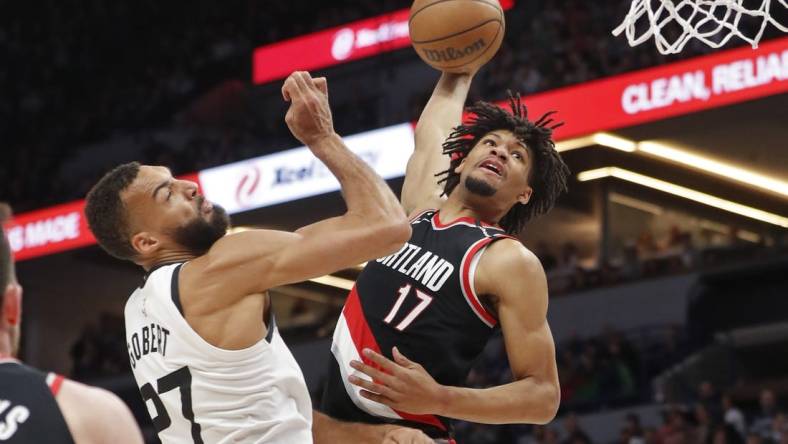 Apr 2, 2023; Minneapolis, Minnesota, USA; Portland Trail Blazers guard Shaedon Sharpe (17) looks to dunk on Minnesota Timberwolves center Rudy Gobert (27) in the first quarter at Target Center. Mandatory Credit: Bruce Kluckhohn-USA TODAY Sports