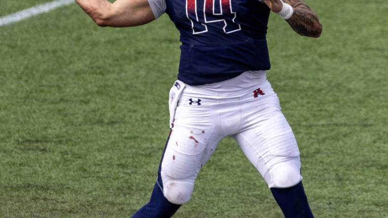 Apr 2, 2023; Houston, TX, USA;  Houston Roughnecks quarterback Cole McDonald (14) drops back to pass against the  St. Louis Battlehawks  linebacker Carson Wells (53) in the fourth quarter at TDECU Stadium. Mandatory Credit: Thomas Shea-USA TODAY Sports