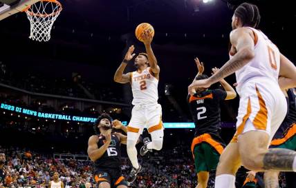 Mar 26, 2023; Kansas City, MO, USA; Texas Longhorns guard Arterio Morris (2) shoots against Miami (Fl) Hurricanes forward Norchad Omier (15) and guard Isaiah Wong (2) during the second half of an Elite 8 college basketball game in the Midwest Regional of the 2023 NCAA Tournament at T-Mobile Center. Mandatory Credit: Jay Biggerstaff-USA TODAY Sports