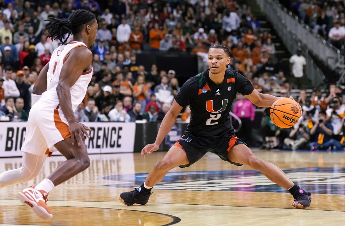Mar 26, 2023; Kansas City, MO, USA; Miami (Fl) Hurricanes guard Isaiah Wong (2) dribbles the ball against Texas Longhorns guard Marcus Carr (5) during the second half of an Elite 8 college basketball game in the Midwest Regional of the 2023 NCAA Tournament at T-Mobile Center. Mandatory Credit: Jay Biggerstaff-USA TODAY Sports