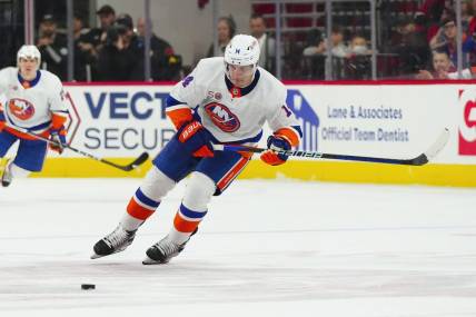 Apr 2, 2023; Raleigh, North Carolina, USA;  New York Islanders center Bo Horvat (14) skates with the puck against the Carolina Hurricanes during the second period at PNC Arena. Mandatory Credit: James Guillory-USA TODAY Sports