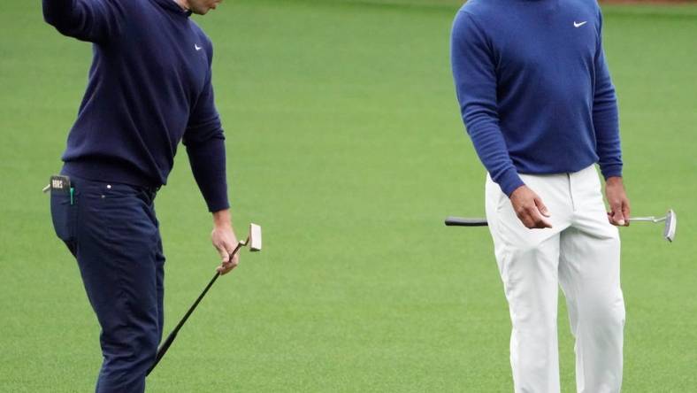 Apr 3, 2023; Augusta, Georgia, USA; Rory McIlroy and Tiger Woods chat on the no. 11 fairway after hitting their approach shots during a practice round for The Masters golf tournament at Augusta National Golf Club. Mandatory Credit: Kyle Terada-USA TODAY Network