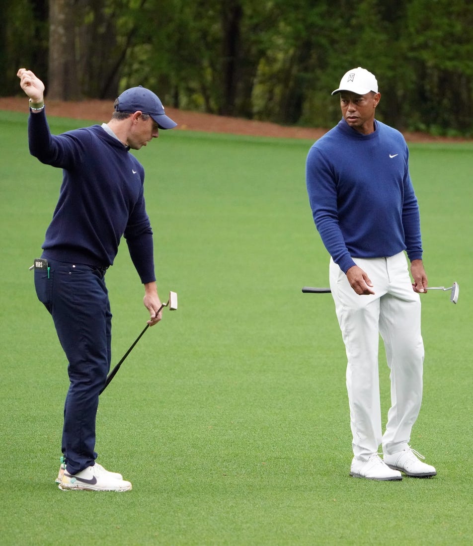 Apr 3, 2023; Augusta, Georgia, USA; Rory McIlroy and Tiger Woods chat on the no. 11 fairway after hitting their approach shots during a practice round for The Masters golf tournament at Augusta National Golf Club. Mandatory Credit: Kyle Terada-USA TODAY Network