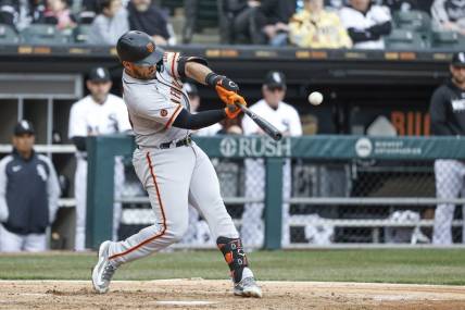 Apr 3, 2023; Chicago, Illinois, USA; San Francisco Giants third baseman David Villar (32) hits a solo home run against the Chicago White Sox during the fifth inning at Guaranteed Rate Field. Mandatory Credit: Kamil Krzaczynski-USA TODAY Sports