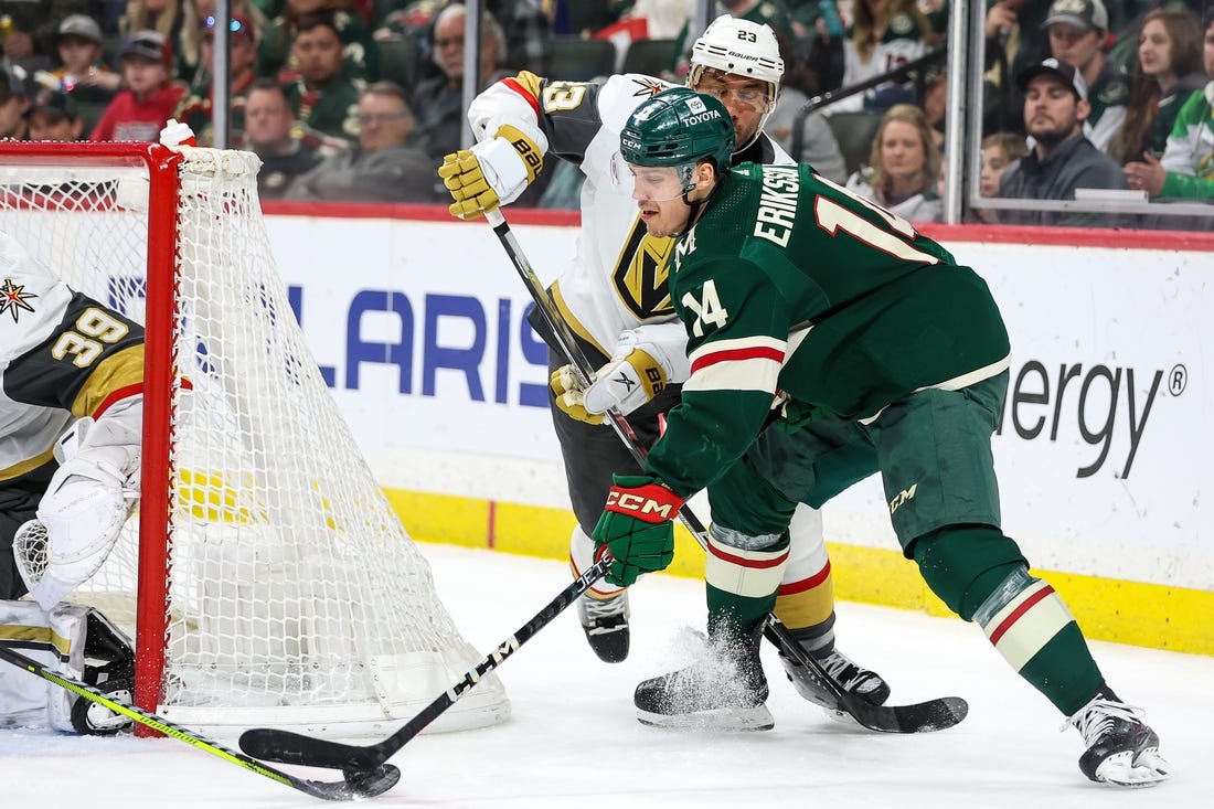 Apr 3, 2023; Saint Paul, Minnesota, USA; Minnesota Wild center Joel Eriksson Ek (14) shoots while Vegas Golden Knights defenseman Alec Martinez (23) defends during the second period at Xcel Energy Center. Mandatory Credit: Matt Krohn-USA TODAY Sports