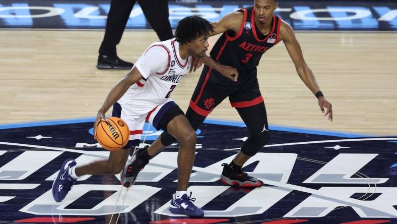 Apr 3, 2023; Houston, TX, USA; Connecticut Huskies guard Tristen Newton (2) shoots the ball as San Diego State Aztecs guard Micah Parrish (3) defends during the first half in the national championship game of the 2023 NCAA Tournament at NRG Stadium. Mandatory Credit: Troy Taormina-USA TODAY Sports