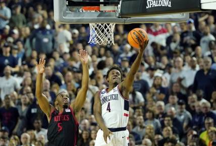 Apr 3, 2023; Houston, TX, USA; Connecticut Huskies guard Nahiem Alleyne (4) shoots the ball against San Diego State Aztecs guard Lamont Butler (5) during the first half in the national championship game of the 2023 NCAA Tournament at NRG Stadium. Mandatory Credit: Bob Donnan-USA TODAY Sports