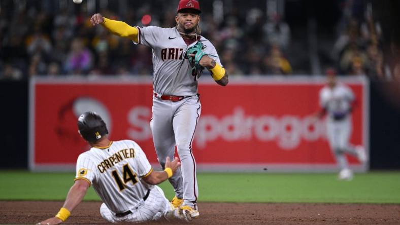 Apr 3, 2023; San Diego, California, USA; Arizona Diamondbacks second baseman Ketel Marte (4) throws to first base after forcing out San Diego Padres designated hitter Matt Carpenter (14) at second base to complete a double play during the third inning at Petco Park. Mandatory Credit: Orlando Ramirez-USA TODAY Sports