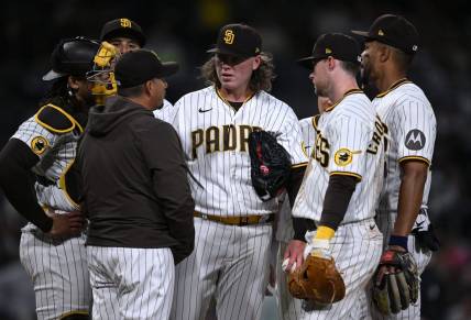 Apr 3, 2023; San Diego, California, USA; San Diego Padres starting pitcher Ryan Weathers (center) meets with pitching coach Ruben Niebla (front, left) at the mound during the third inning against the Arizona Diamondbacks at Petco Park. Mandatory Credit: Orlando Ramirez-USA TODAY Sports