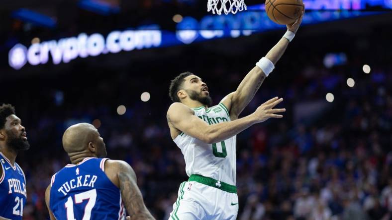 Apr 4, 2023; Philadelphia, Pennsylvania, USA; Boston Celtics forward Jayson Tatum (0) drives for a score past Philadelphia 76ers forward P.J. Tucker (17) and center Joel Embiid (21) during the second quarter at Wells Fargo Center. Mandatory Credit: Bill Streicher-USA TODAY Sports