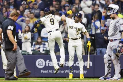 Apr 4, 2023; Milwaukee, Wisconsin, USA;  Milwaukee Brewers third baseman Brian Anderson (9) celebrates with center fielder Garrett Mitchell (5) after hitting a home run during the sixth inning against the New York Mets at American Family Field. Mandatory Credit: Jeff Hanisch-USA TODAY Sports