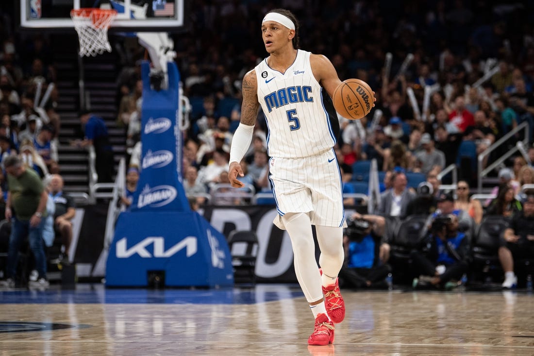 Apr 4, 2023; Orlando, Florida, USA; Orlando Magic forward Paolo Banchero (5) dribbles the ball against the Cleveland Cavaliers in the third quarter at Amway Center. Mandatory Credit: Jeremy Reper-USA TODAY Sports