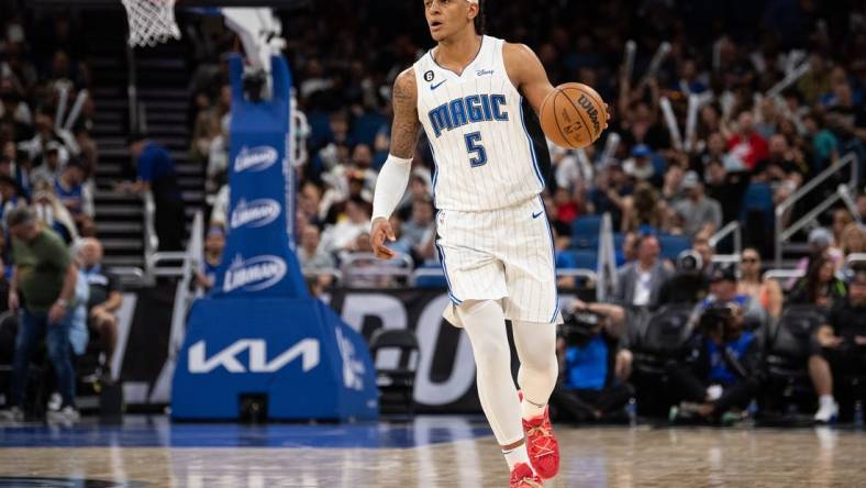 Apr 4, 2023; Orlando, Florida, USA; Orlando Magic forward Paolo Banchero (5) dribbles the ball against the Cleveland Cavaliers in the third quarter at Amway Center. Mandatory Credit: Jeremy Reper-USA TODAY Sports