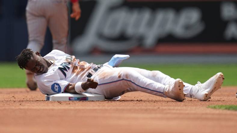 Apr 5, 2023; Miami, Florida, USA;  Miami Marlins center fielder Jazz Chisholm Jr. (2) gets up slowly after getting tagged out trying to steal second base in the first inning against the Minnesota Twins at loanDepot Park. Mandatory Credit: Jim Rassol-USA TODAY Sports