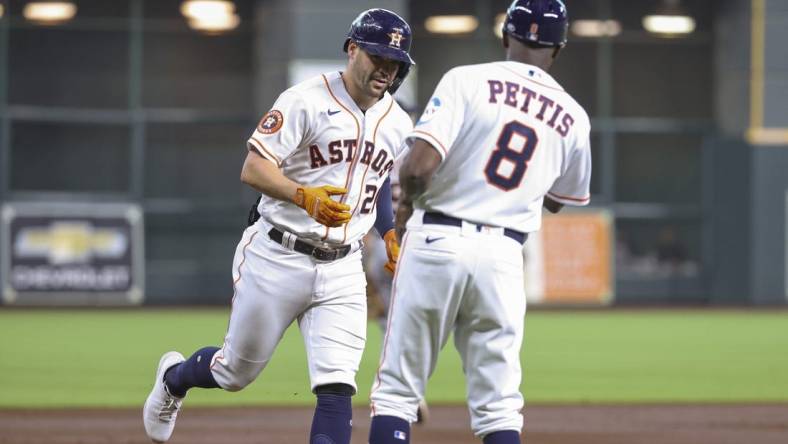 Apr 5, 2023; Houston, Texas, USA; Houston Astros center fielder Chas McCormick (20) celebrates with third base coach Gary Pettis (8) after hitting a home run during the second inning against the Detroit Tigers at Minute Maid Park. Mandatory Credit: Troy Taormina-USA TODAY Sports