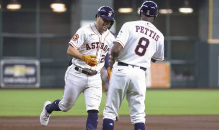 Apr 5, 2023; Houston, Texas, USA; Houston Astros center fielder Chas McCormick (20) celebrates with third base coach Gary Pettis (8) after hitting a home run during the second inning against the Detroit Tigers at Minute Maid Park. Mandatory Credit: Troy Taormina-USA TODAY Sports