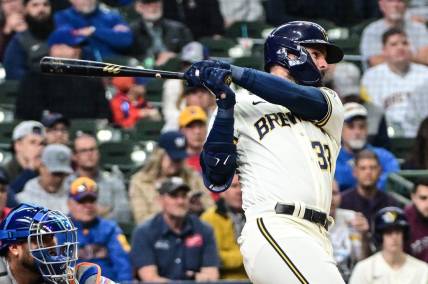 Apr 5, 2023; Milwaukee, Wisconsin, USA; Milwaukee Brewers designated hitter Jesse Winker (33) hits a double to drive in two runs in the fifth inning against the New York Mets at American Family Field. Mandatory Credit: Benny Sieu-USA TODAY Sports