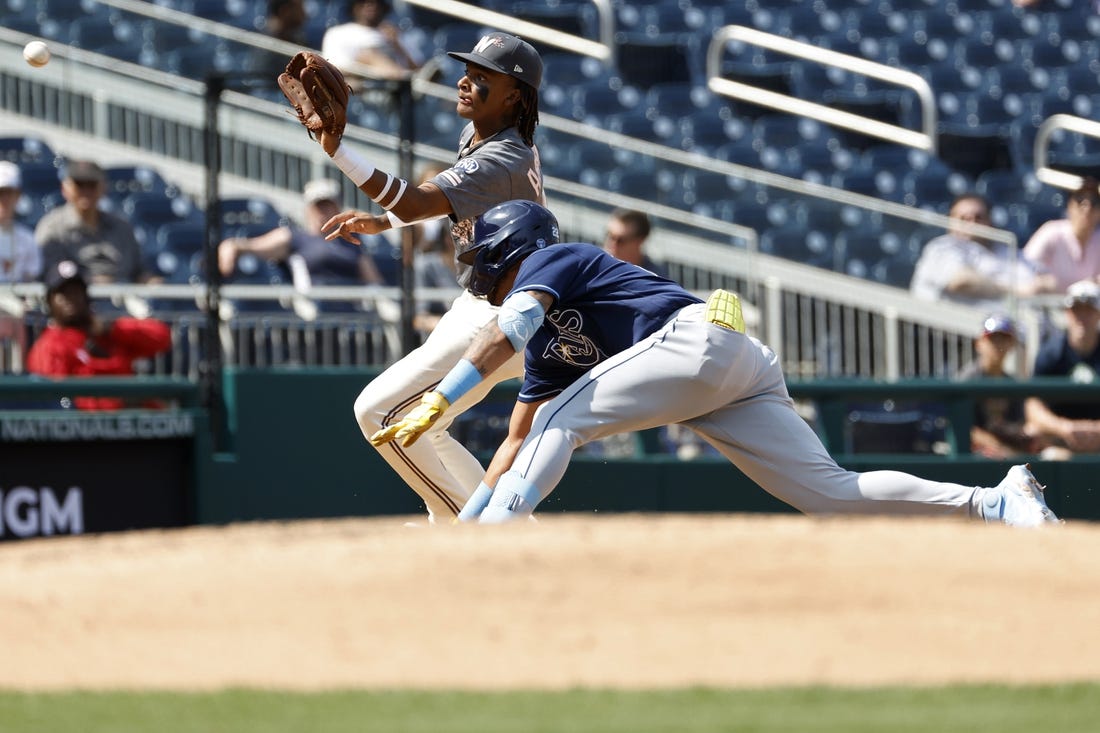 Apr 5, 2023; Washington, District of Columbia, USA; Tampa Bay Rays center fielder Jose Siri (22) is tagged out at third base on a throw to Washington Nationals shortstop CJ Abrams (5) during the sixth inning at Nationals Park. Mandatory Credit: Geoff Burke-USA TODAY Sports