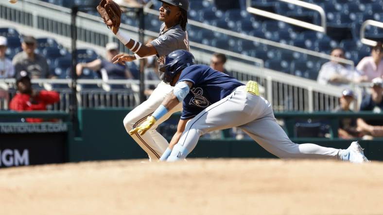 Apr 5, 2023; Washington, District of Columbia, USA; Tampa Bay Rays center fielder Jose Siri (22) is tagged out at third base on a throw to Washington Nationals shortstop CJ Abrams (5) during the sixth inning at Nationals Park. Mandatory Credit: Geoff Burke-USA TODAY Sports