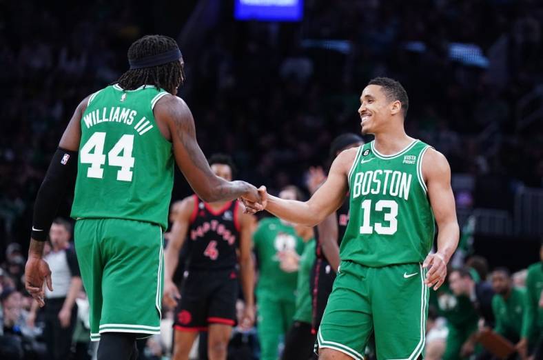 Apr 5, 2023; Boston, Massachusetts, USA; Boston Celtics guard Malcolm Brogdon (13) reacts after his three point basket with center Robert Williams III (44) against the Toronto Raptors in the second quarter at TD Garden. Mandatory Credit: David Butler II-USA TODAY Sports