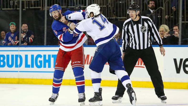 Apr 5, 2023; New York, New York, USA; New York Rangers defenseman Ben Harpur (5) fights Tampa Bay Lightning left wing Pat Maroon (14) during the first period at Madison Square Garden. Mandatory Credit: Danny Wild-USA TODAY Sports