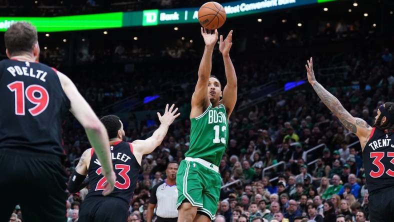 Apr 5, 2023; Boston, Massachusetts, USA; Boston Celtics guard Malcolm Brogdon (13) shoots the ball against Toronto Raptors guard Fred VanVleet (23) in the second half at TD Garden. Mandatory Credit: David Butler II-USA TODAY Sports