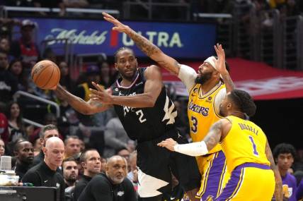 Apr 5, 2023; Los Angeles, California, USA; LA Clippers forward Kawhi Leonard (2) passes the ball against Los Angeles Lakers forward Anthony Davis (3) and guard D'Angelo Russell (1)  in the second half at Crypto.com Arena. Mandatory Credit: Kirby Lee-USA TODAY Sports