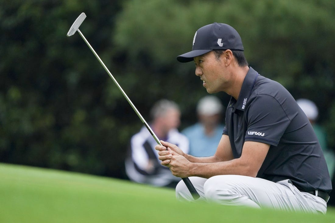 Apr 6, 2023; Augusta, Georgia, USA; Kevin Na lines up his putt on the first green during the first round of The Masters golf tournament. Mandatory Credit: Katie Goodale-USA TODAY Network