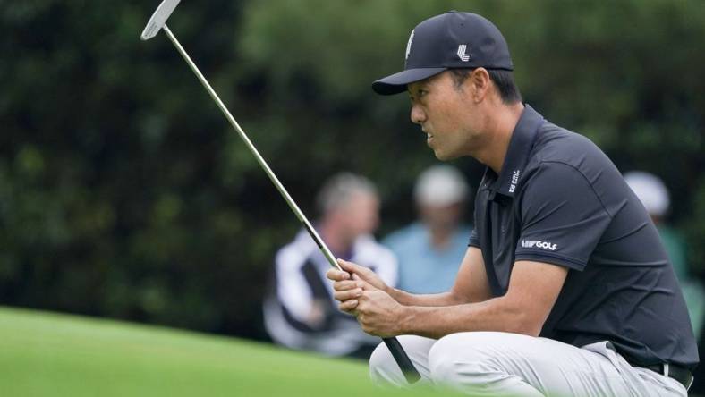 Apr 6, 2023; Augusta, Georgia, USA; Kevin Na lines up his putt on the first green during the first round of The Masters golf tournament. Mandatory Credit: Katie Goodale-USA TODAY Network