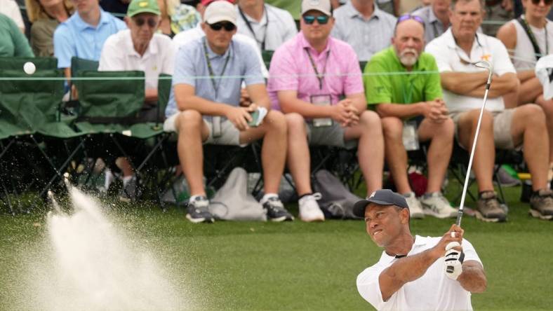 Apr 6, 2023; Augusta, Georgia, USA; Tiger Woods plays a shot from a bunker on the 18th hole during the first round of The Masters golf tournament. Mandatory Credit: Michael Madrid-USA TODAY Network

Pga Masters Tournament First Round