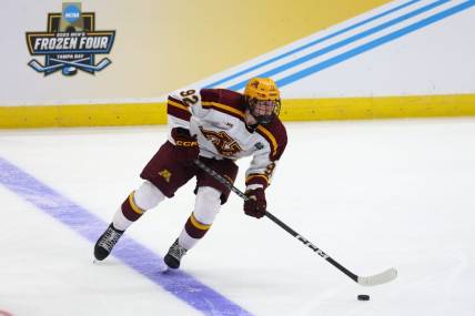 Apr 6, 2023; Tampa, Florida, USA; Minnesota forward Logan Cooley (92) controls the puck against Boston University during the second period in the semifinals of the 2023 Frozen Four college ice hockey tournament at Amalie Arena. Mandatory Credit: Nathan Ray Seebeck-USA TODAY Sports