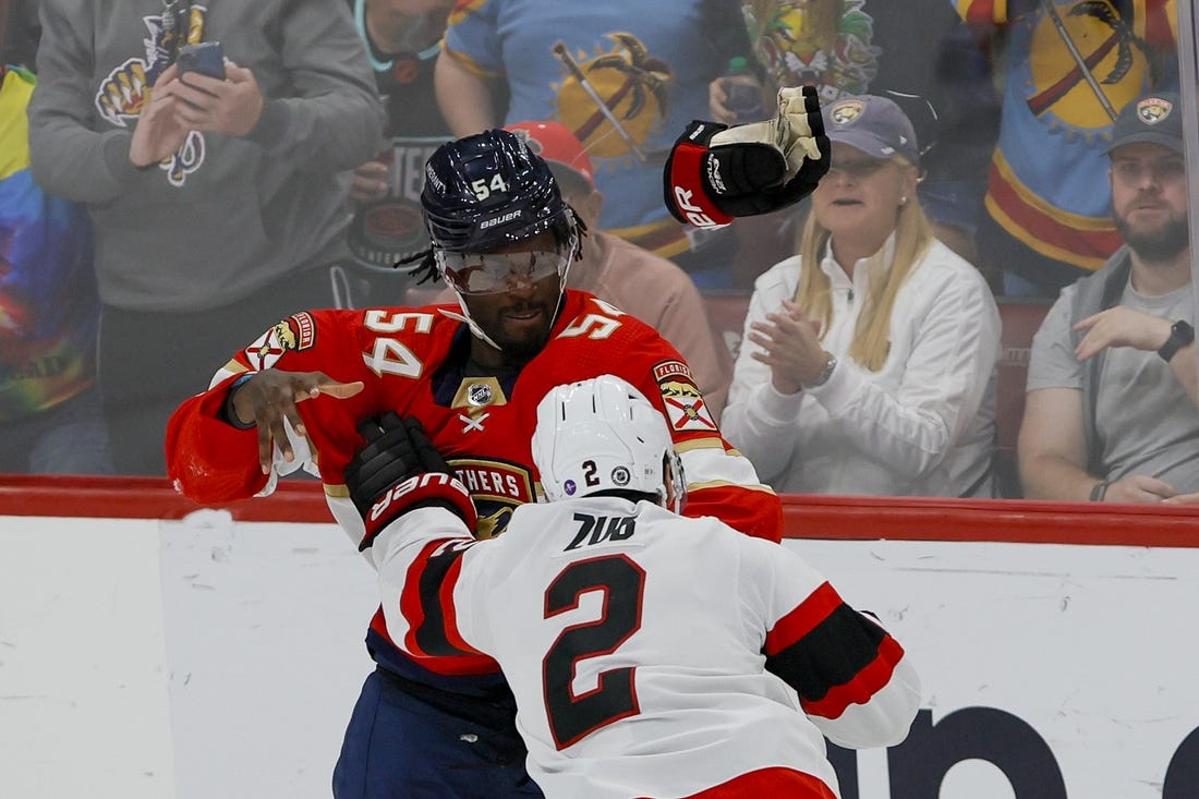 Apr 6, 2023; Sunrise, Florida, USA; Florida Panthers right wing Givani Smith (54) and Ottawa Senators defenseman Artem Zub (2) fight during the third period at FLA Live Arena. Mandatory Credit: Sam Navarro-USA TODAY Sports