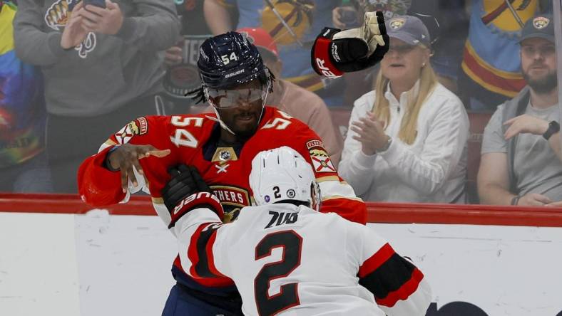 Apr 6, 2023; Sunrise, Florida, USA; Florida Panthers right wing Givani Smith (54) and Ottawa Senators defenseman Artem Zub (2) fight during the third period at FLA Live Arena. Mandatory Credit: Sam Navarro-USA TODAY Sports