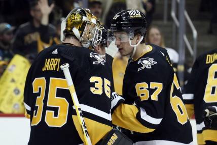 Apr 6, 2023; Pittsburgh, Pennsylvania, USA; Pittsburgh Penguins goaltender Tristan Jarry (35) and Pittsburgh Penguins right wing Rickard Rakell (67) celebrate after defeating the Minnesota Wild at PPG Paints Arena. Pittsburgh won 4-1. Mandatory Credit: Charles LeClaire-USA TODAY Sports