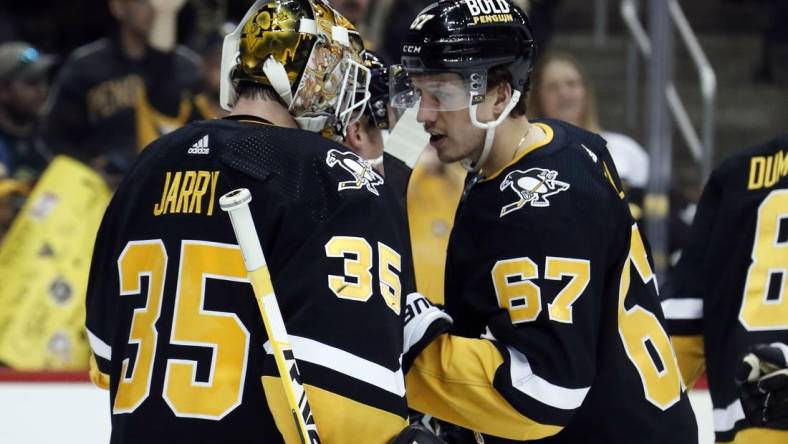 Apr 6, 2023; Pittsburgh, Pennsylvania, USA; Pittsburgh Penguins goaltender Tristan Jarry (35) and Pittsburgh Penguins right wing Rickard Rakell (67) celebrate after defeating the Minnesota Wild at PPG Paints Arena. Pittsburgh won 4-1. Mandatory Credit: Charles LeClaire-USA TODAY Sports