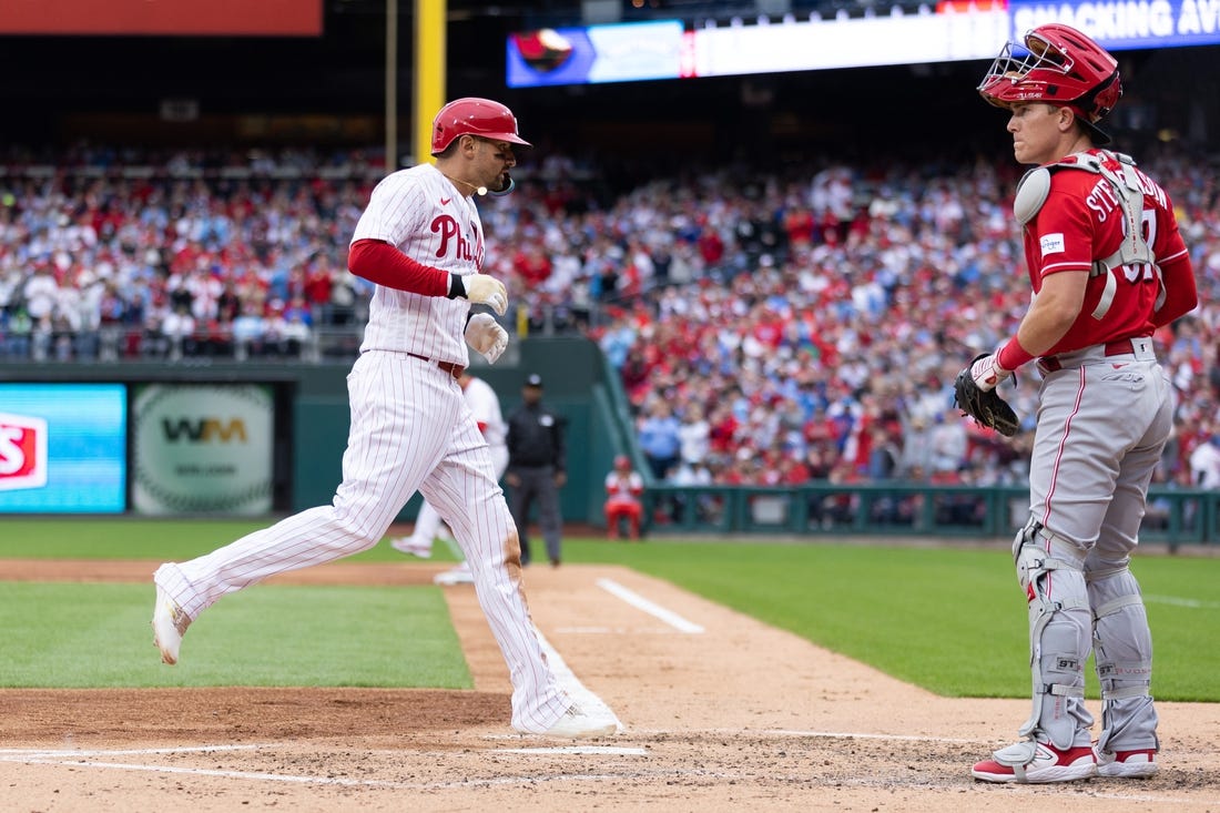 Apr 7, 2023; Philadelphia, Pennsylvania, USA; Philadelphia Phillies right fielder Nick Castellanos (8) crosses home plate in front of Cincinnati Reds catcher Tyler Stephenson (37) on a bases loaded walk during the second inning at Citizens Bank Park. Mandatory Credit: Bill Streicher-USA TODAY Sports