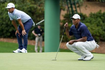 Apr 7, 2023; Augusta, Georgia, USA; Xander Schauffele and Tiger Woods line up putts on the tenth green during the second round of The Masters golf tournament. Mandatory Credit: Danielle Parhizkaran-USA TODAY Network