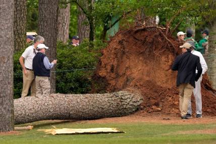 Volunteers and staff secure the area around where a tree fell near the 17th tee.

Pga Masters Tournament Second Round