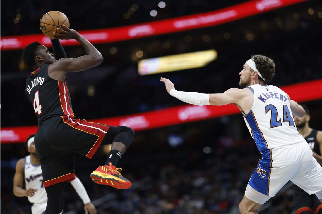 Apr 7, 2023; Washington, District of Columbia, USA; Miami Heat guard Victor Oladipo (4) shoots the ball over Washington Wizards forward Corey Kispert (24) in the second quarterat Capital One Arena. Mandatory Credit: Geoff Burke-USA TODAY Sports