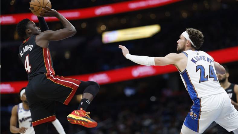 Apr 7, 2023; Washington, District of Columbia, USA; Miami Heat guard Victor Oladipo (4) shoots the ball over Washington Wizards forward Corey Kispert (24) in the second quarterat Capital One Arena. Mandatory Credit: Geoff Burke-USA TODAY Sports