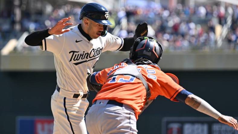 Apr 8, 2023; Minneapolis, Minnesota, USA; Minnesota Twins shortstop Carlos Correa (4) is tagged out at home by Houston Astros catcher Martin Maldonado (15) during the second inning at Target Field. Mandatory Credit: Jeffrey Becker-USA TODAY Sports